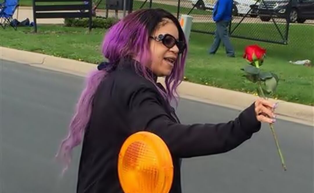 Tyka Nelson holds a rose outside Paisley Park on Thursday, April 21, 2016. (Photo: AP).