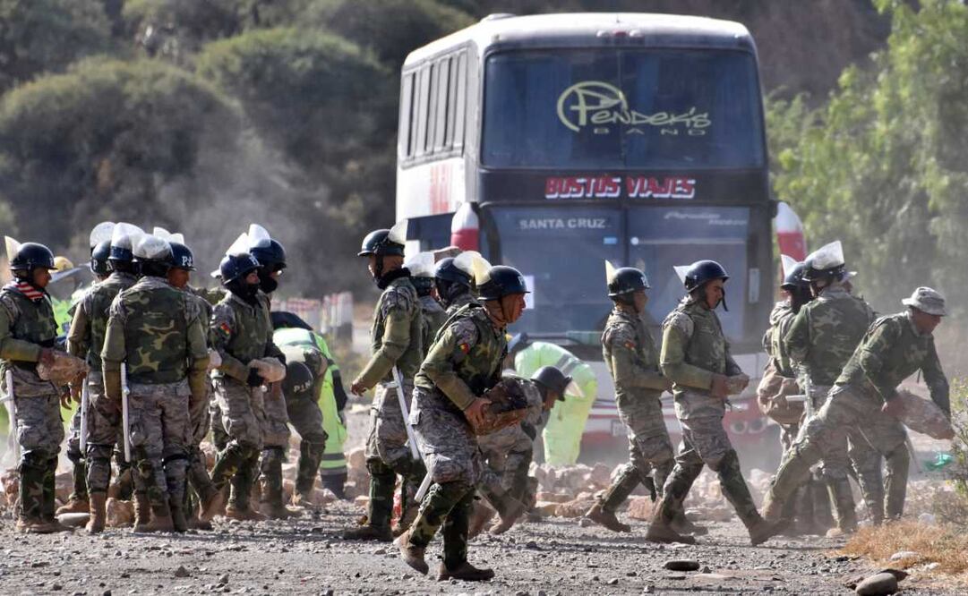 La policía militar despeja una carretera que estaba bloqueada por partidarios del expresidente de Bolivia, Evo Morales. Foto: AP  / Dico Soliz
