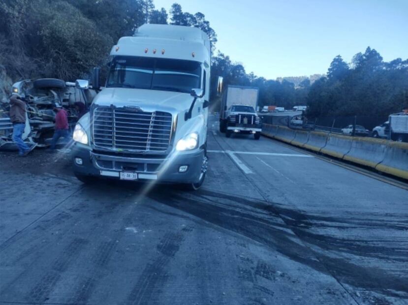 Tráiler cargado con alimento para perros vuelca en la México-Puebla; conductor pierde la vida