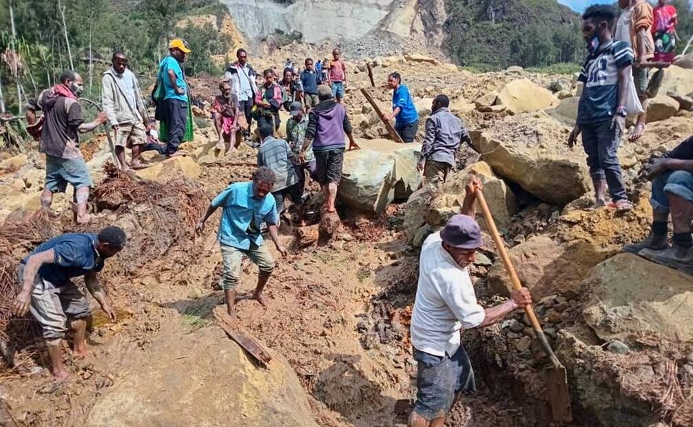 Habitantes locales cavando entre los escombros para buscar a familiares desaparecidos en el lugar del deslizamiento de tierra. Foto: EFE