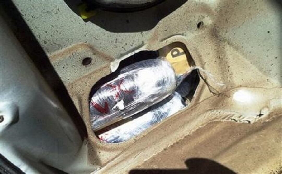Packages of hard drugs are seen in the rear driver side quarter panel of a car carrying more than US$377,000 worth of heroin and methamphetamine, seized at the U.S.-Mexico border port of entry in Nogales, Arizona (AP)