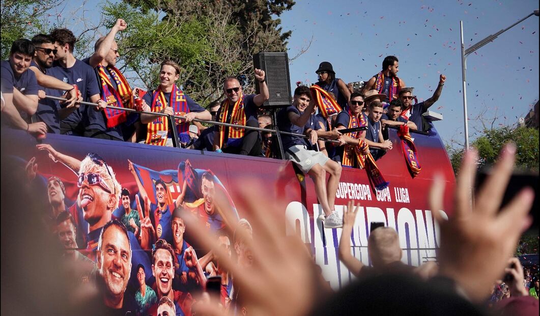 El entrenador alemán Hans-Dieter Flick (centro) y los jugadores, del Barcelona, viajan en un autobús descapotable para celebrar la conquista de su 28 título de Liga en Barcelona, España, el 16 de mayo de 2025. Foto: AFP