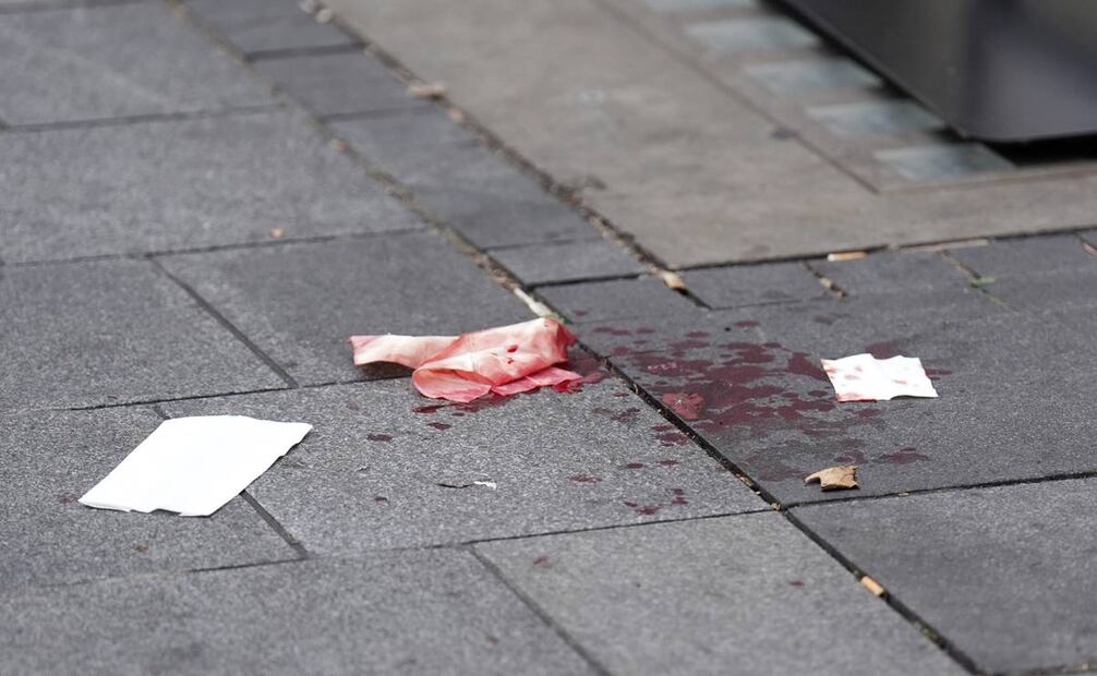 Se ve sangre en el pavimento cuando un hombre fue arrestado después de que una niña de 11 años y una mujer de 34 fueran apuñaladas. Foto: AP