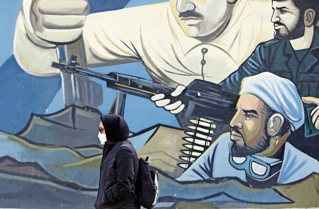 Una mujer pasa junto a un mural de soldados de la Guardia Revolucionaria iraní en una calle de Teherán. Foto: EFE