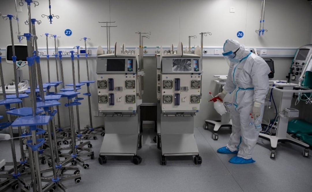 This photo taken on April 14, 2020 shows a staff member spraying disinfectant on medical equipment - Photo: File photo/STR/AFP