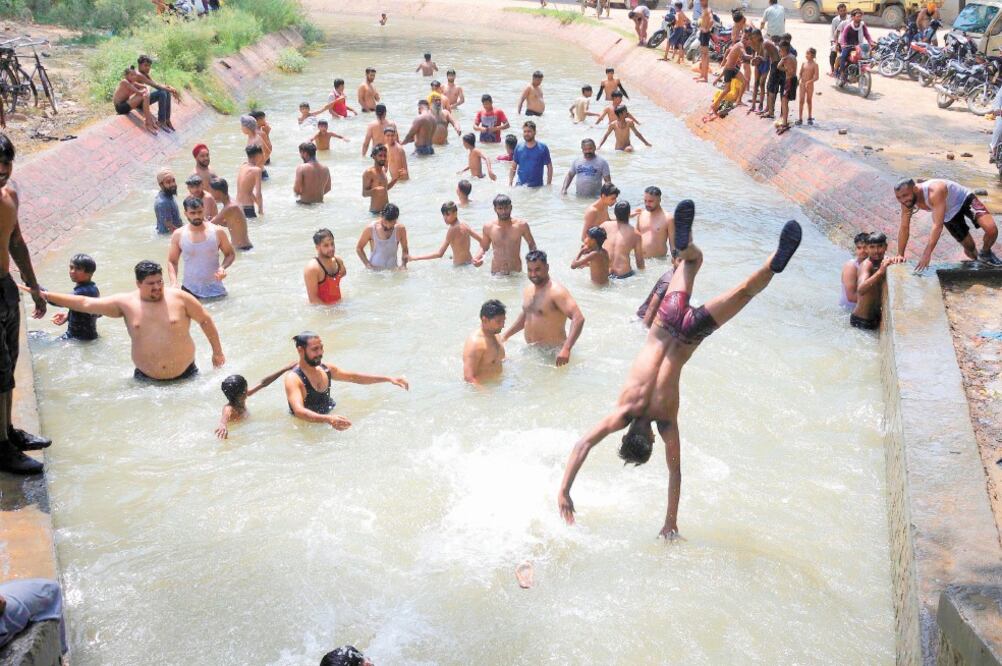 Varias personas se refrescaron ayer en un canal debido a la ola de calor que se sintió en Amritsar, India. Foto: RAMINDER PAL SINGH. EFE