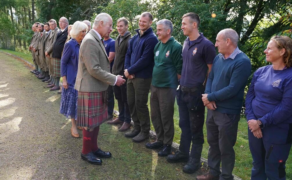 La monarca Camilla y el rey Carlos III se reúnen con el personal de la finca cuando se van después de asistir a un servicio religioso en el pueblo de Crathie, cerca de Balmoral, en el centro de Escocia, para conmemorar la vida de la madre del rey, Su difunta Majestad la Reina Isabel II en el primer aniversario de su fallecimiento.  Foto: AFP