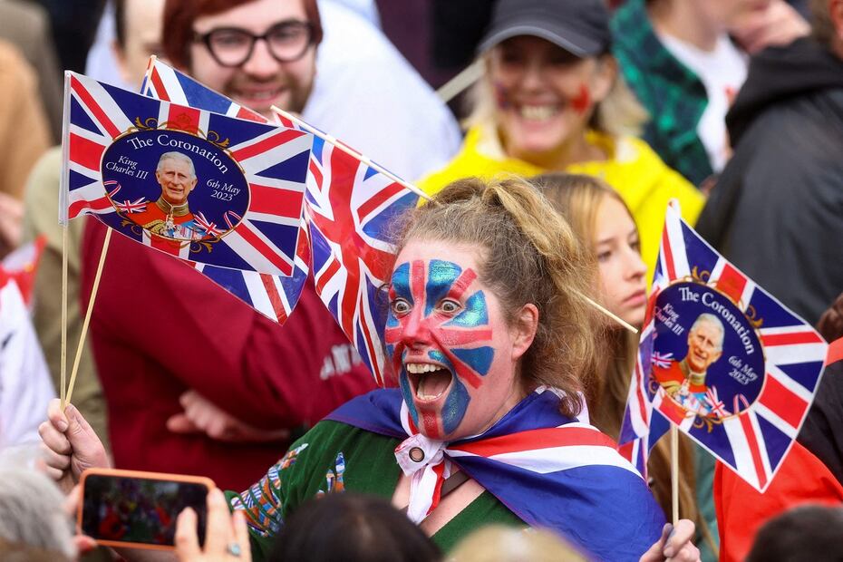 Una fan real posa para una foto mientras bordea la ruta de la 'Procesión del Rey', un tramo de dos kilómetros desde el Palacio de Buckingham hasta la Abadía de Westminster, mientras esperan que el Rey Carlos III y la reina Camila pasen en el Diamond State Coach, en el centro de Londres. Foto: AFP