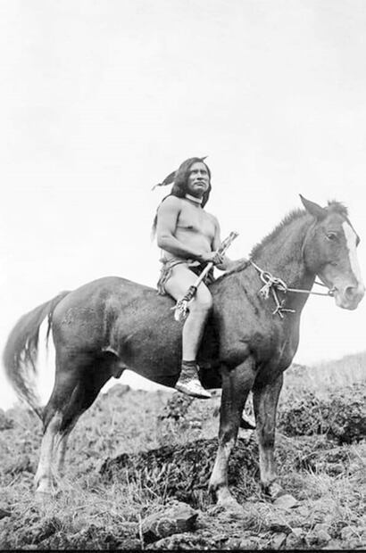 Un apache posa para la cámara sobre su caballo. En la mano su arma, luce taparrabo y su pluma en la cabeza, tal vez la imagen más emblemática que se tiene de estas comunidades. Cortesía Mario Trillo.