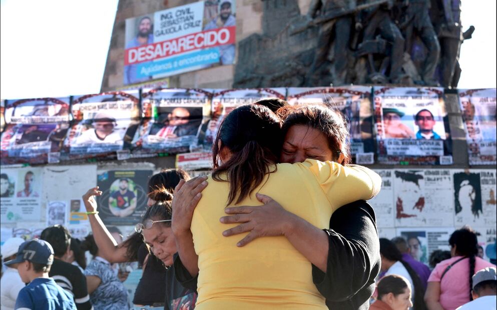 Familiares de personas que presuntamente perdieron la vida en el rancho Izaguirre se abrazan durante una misa en la Glorieta de los Desparecidos en Guadalajara, Jalisco, el 14 de marzo de 2025. Foto: AFP