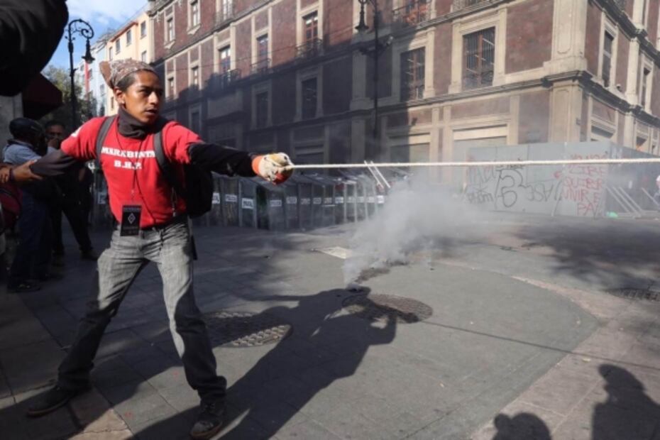 Embozados pintan edificios públicos y lanzan cohetón en marcha por 2 de Octubre