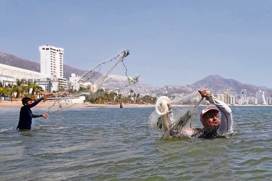 Andrés Estrada y su hijo acudieron a la playa aunque las condiciones para pescar no eran buenas, ya que en el mar hay mucha basura y embarcaciones hundidas. Foto: Valente Rosas / El Universal