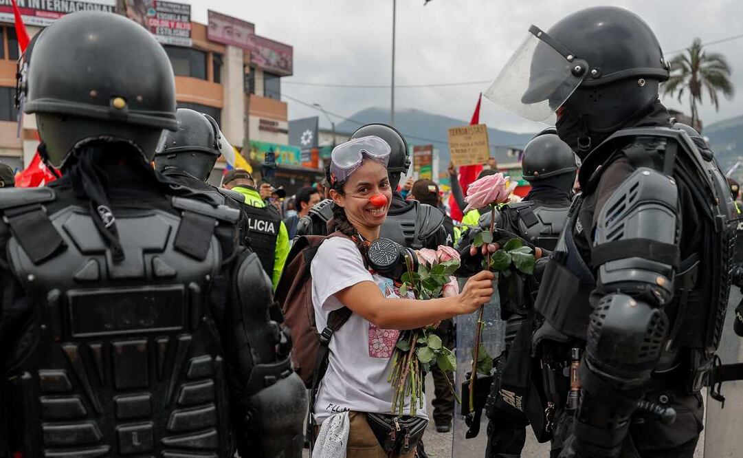 Una persona entrega una flor a un integrante de la policía ecuatoriana durante una protesta contra el Gobierno del presidente de Ecuador, Daniel Noboa, este domingo en Quito (Ecuador). Las protestas, convocadas en todo el país por la Confederación de Nacionalidades Indígenas (Conaie), radican en rechazo a la administración de Noboa y al alza del precio del diésel. Foto: EFE