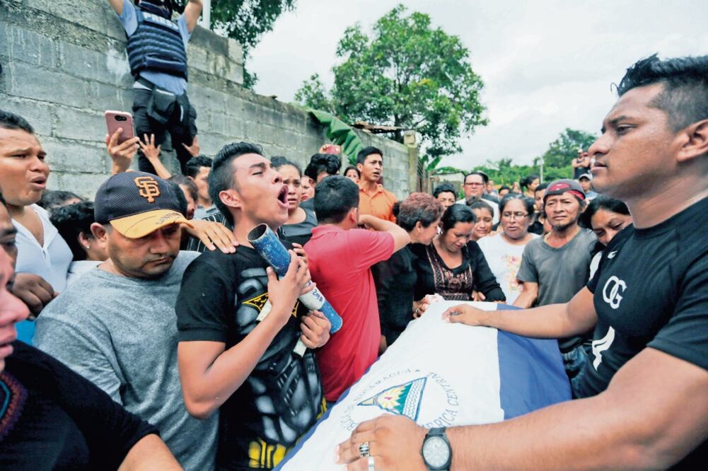 Familiares lloran durante el entierro, ayer en Masaya, de Marvin López, quien murió el martes al recibir un disparo en la garganta durante enfrentamientos con antimotines (INTI OCON. AFP)