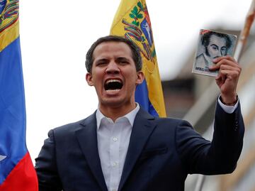 Buoyed by protesters, opposition leader Juan Guaidó claims Venezuela presidency