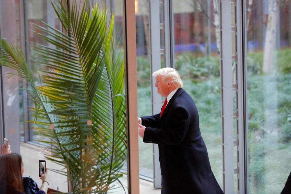 President-elect Donald Trump gestures to diners as he departs the lobby of the New York Times building. REUTERS/Lucas Jackson