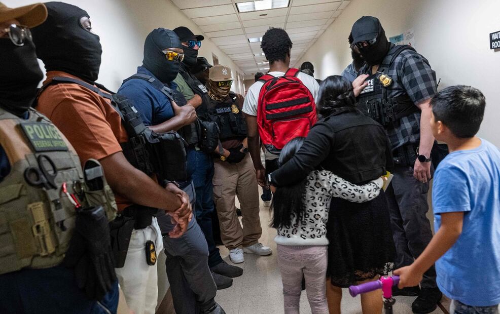 Agentes del ICE observan a un par de niños y a su mamá en los pasillos del tribunal de inmigración en la ciudad de Nueva York, Estados Unidos, el 24 de julio de 2025. Foto: AFP