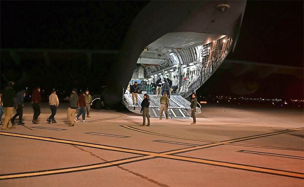 Agentes de Aduanas y Protección Fronteriza guían a un grupo de inmigrantes hacia un Boeing C-17 Globemaster III militar en el Aeropuerto Internacional de Tucson, Arizona, el pasado jueves. (27/01/2025) Foto: TSGT Kimberly Nable | AP