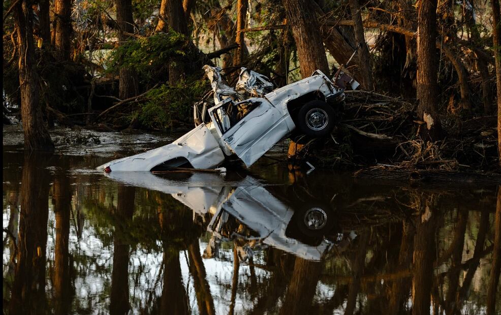 Una camioneta medio sumergida en el río Guadalupe tras ser arrastrada por una inundación repentina en Ingram, Texas, el 8 de julio de 2025. Foto: AFP