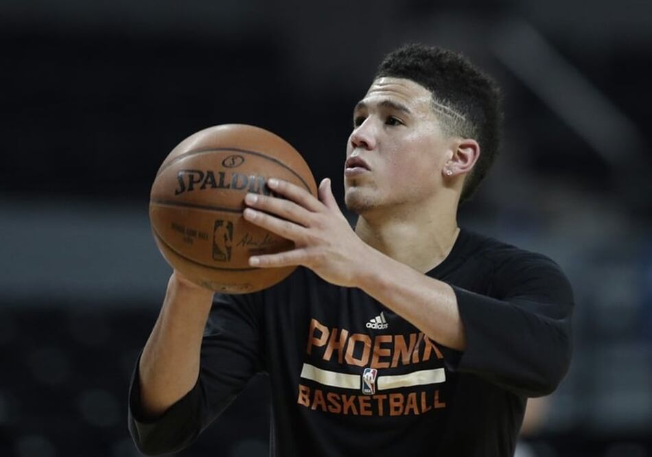 Phoenix Suns' Devin Booker shoot baskets during a training session the day before their game against the Dallas Mavericks, at Mexico City Arena in Mexico City, Wednesday, Jan. 11, 2017. (AP Photo/Rebecca Blackwell)
