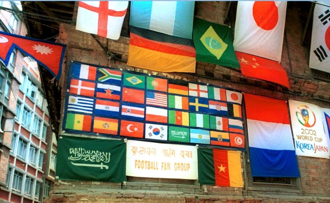 Old house in Katmandu, Nepal, decorated with flags of different countries participating in the 2002 World Cup  - Photo: Binod Joshi/AP