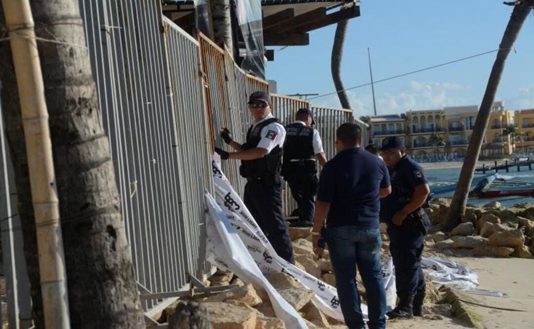 Police officers stand outside the Blue Parrot nightclub - Photo: AP