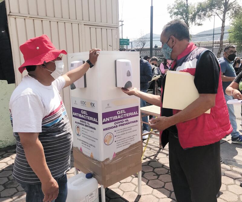 Profesores toman gel antes de entrar a la sede de vacunación. Foto: REBECA JIMÉNEZ. EL UNIVERSAL