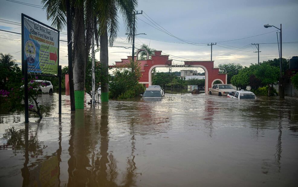 Varios vehículos se observan sumergidos en la entrada de una unidad habitacional en la ciudad de Poza Rica, Veracruz, el viernes 10 de octubre de 2025. Foto AFP