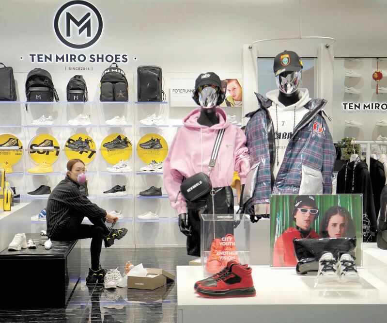 Una cliente se prueba tenis en una tienda en un centro comercial en Beijing. Capri Holdings, la empresa matriz de Versace, Jimmy Choo y otras marcas, espera un impacto en sus negocios debido al coronavirus. Foto: REUTERS