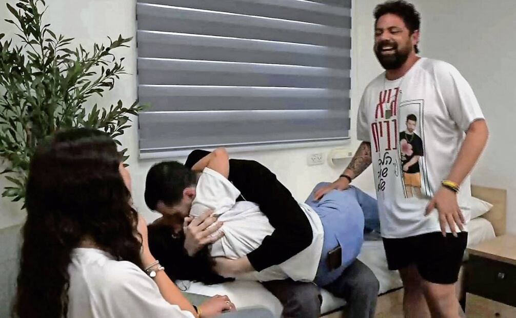 Guy Gilboa-Dalal (de chamarra negra) abraza a su familia, luego de ser liberado por la organización islamista Hamas. Foto: AFP