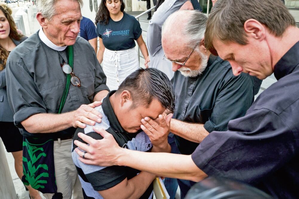 Sacerdotes acompañaron ayer al inmigrante Hermelindo Che Coc a rezar, en Los Ángeles. El guatemalteco fue separado en EU de su hijo de seis años (RICHARD VOGEL. AP)