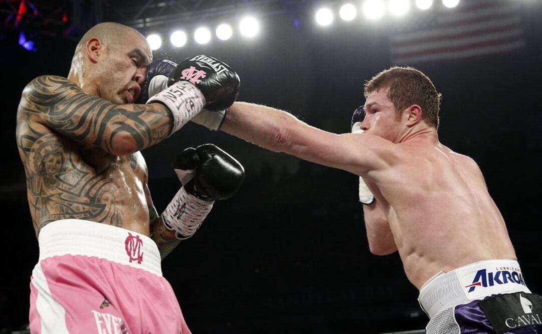 Miguel Cotto gets hit by Canelo Alvarez during their WBC middleweight title bout in Las Vegas.